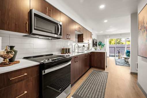 A modern kitchen with dark wood cabinets and a black stove top oven.