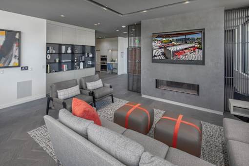 A modern living room with grey sofas and a fireplace.
