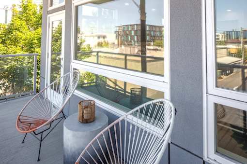 Two chairs are placed on a table outside a building.