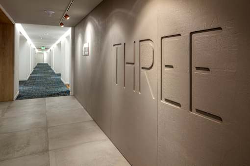 A hallway with the word THREE on the wall.