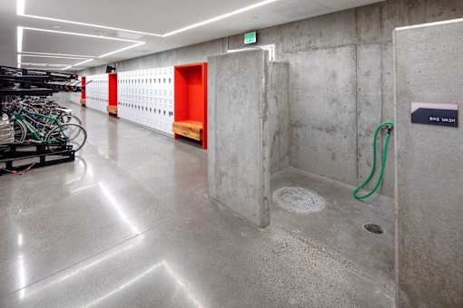 A bike wash area with a green hose.