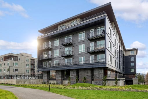 a large apartment building with a sidewalk in front of it