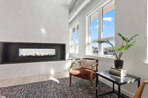 A living room with a fireplace and a chair.