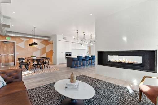 A modern living room with a fireplace and a dining table.