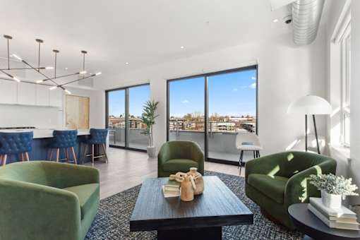 A modern living room with a view of the cityscape outside the large windows.