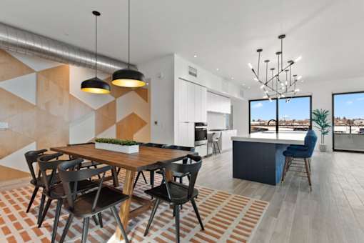 A modern dining room with a wooden table and chairs.
