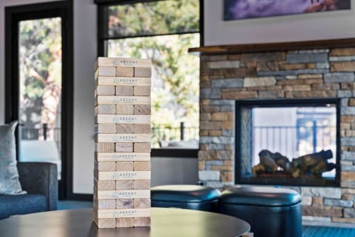 a jenga on a table in a living room with a fireplace
