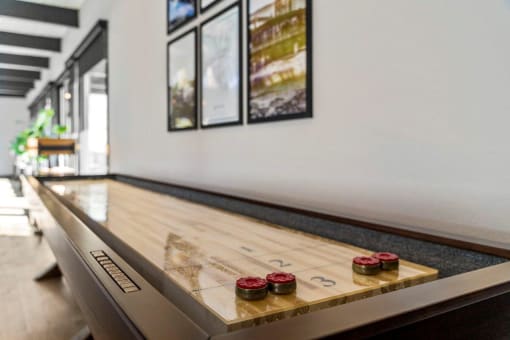 a game table in a living room with red and green buttons on it