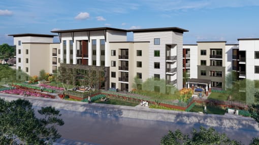 an aerial view of an apartment complex with a pond