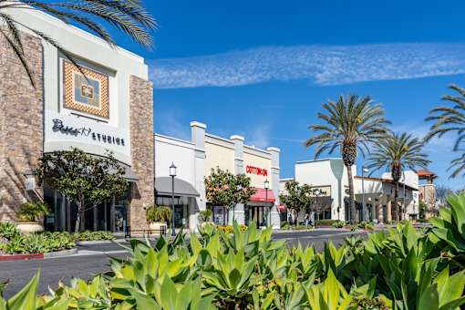 A shopping center with a clear blue sky above.