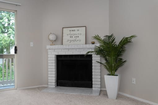Bayview Apartment Homes Living Room Fireplace and Plant