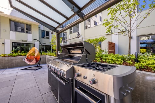 a stainless steel outdoor kitchen with a grill