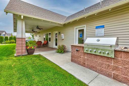 A house with a covered porch and a mailbox on the wall.