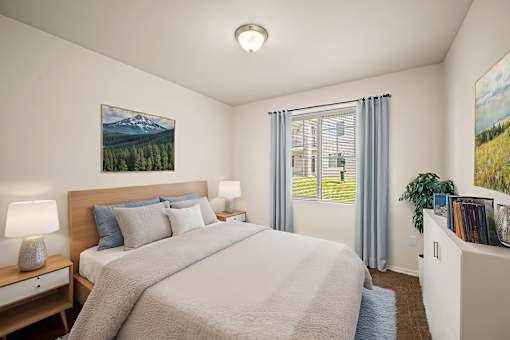 A bedroom with a large bed and a painting of a mountain scene on the wall.