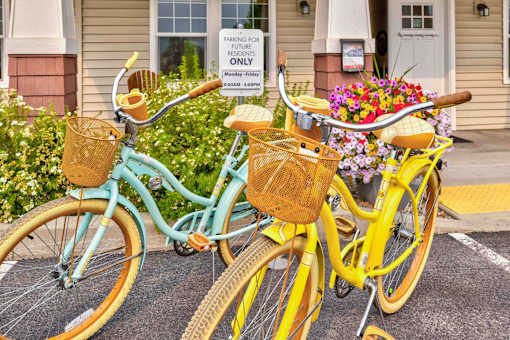 Two bicycles are parked in front of a house with a sign that says "PARKING FOR FUTURE ONLY".