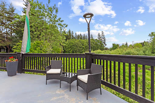 A patio with a table and chairs and a lamp post.