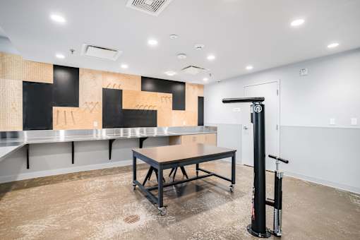 A room with a table and a black pole with a red and white sign on it.