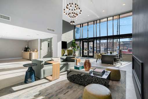 A modern living room with a large window and a variety of furniture.
