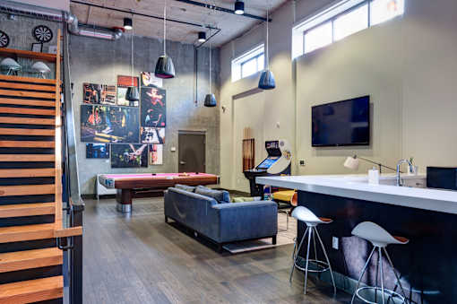 A room with a couch, a table, and a television.