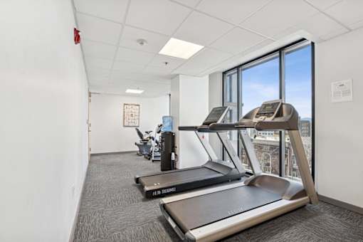 A gym with treadmills and a weight machine.