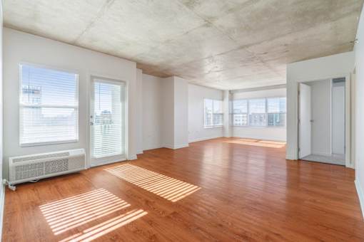 A room with wooden floors and white walls.