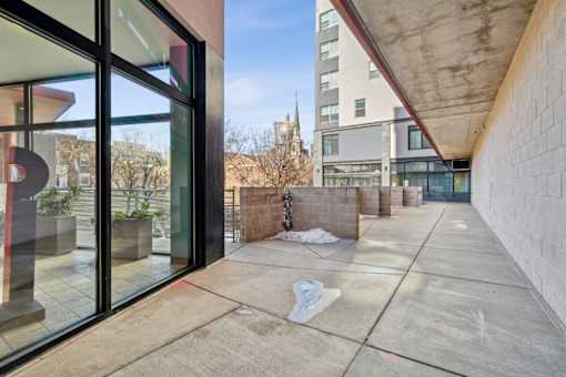 A view of a courtyard with a building in the background.