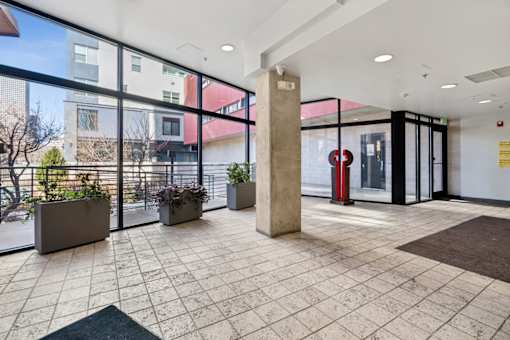 A large open space with a tiled floor and a pillar in the middle.
