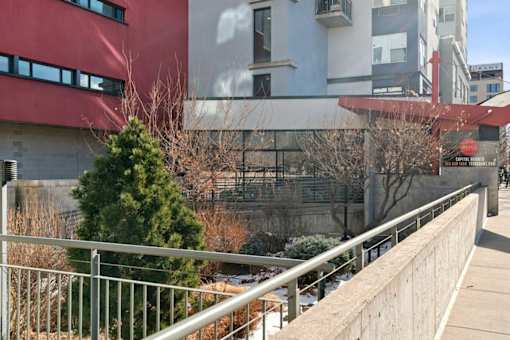 A building with a red and white exterior and a tree in front of it.