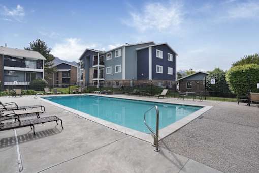 A swimming pool in front of apartment buildings.