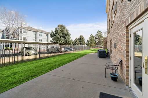 A residential area with a sidewalk and a building on the right.