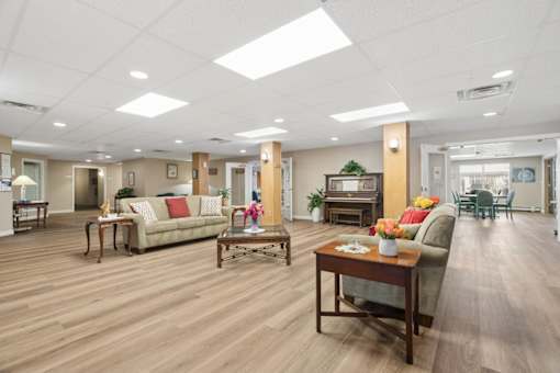 A spacious living room with wooden floors and furniture.