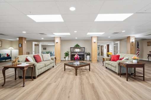 A spacious living room with wooden floors and furniture.