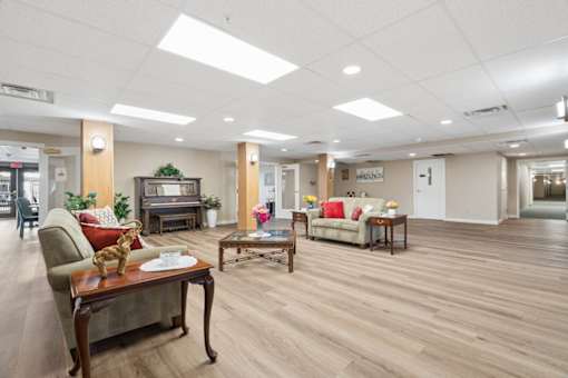 A spacious living room with wooden floors and furniture.