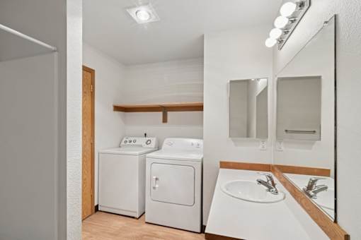 A small bathroom with a washer and dryer.