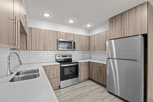 a kitchen with stainless steel appliances and wooden cabinets