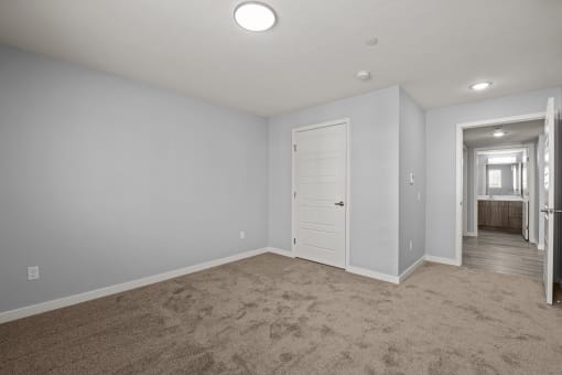 bedroom with closet door and view of the bathroom