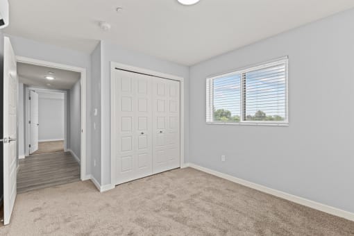 an empty room with a door and a window