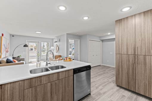 a kitchen with wooden cabinets and a stainless steel dishwasher