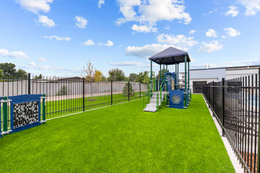 a playground with a swing set in the middle of a yard