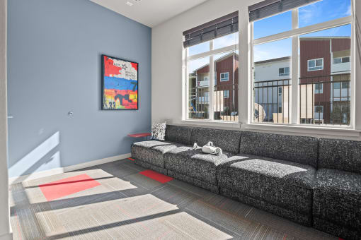 a living room with a couch and large windows