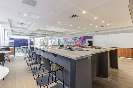 A long bar with chairs on either side.