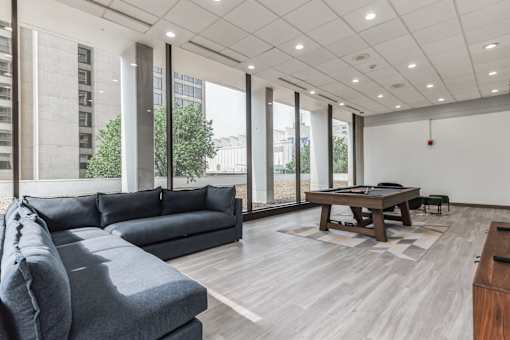 A modern living room with a grey sofa and a wooden coffee table.