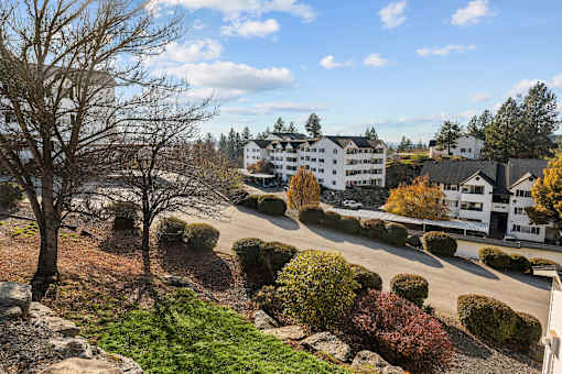 an aerial view of a building with a street and trees