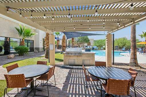 A patio with a table and chairs under a canopy.