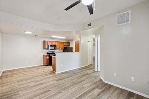 A room with a wooden floor and a ceiling fan.