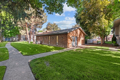 Curtis Apartments  brick building with a sidewalk and grass