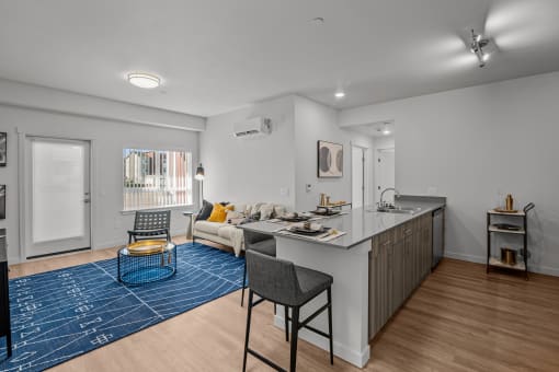 a living room with a kitchen counter and a couch