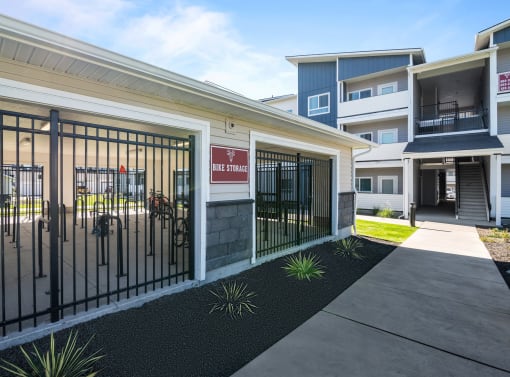 a courtyard with a gate in front of a building with apartments