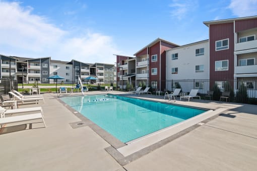 a swimming pool in front of an apartment building