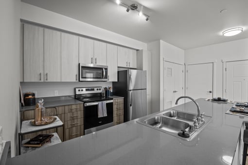 a kitchen with stainless steel appliances and a sink